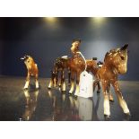 A group of four assorted Beswick ponies