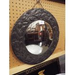 A hammered pewter circular wall mirror with floral decoration together with a modern gilt framed