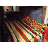 A South American style multi-coloured bed cover,