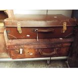 An early 20thC tan leather suitcase plus another similar