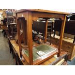 A mahogany two tier side table with tooled leather insert