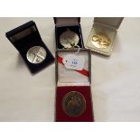 Four assorted sporting medallions in boxes