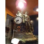 A French spelter mantel clock in the form of a young boy with bird,