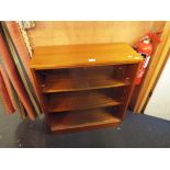 A retro teak bookcase with glass sliding doors