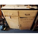 A 1950's cream painted metal kitchen unit fitted with two drawers over a pair of cupboard doors