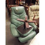 A green upholstered faux leather reclining armchair with matching footstool