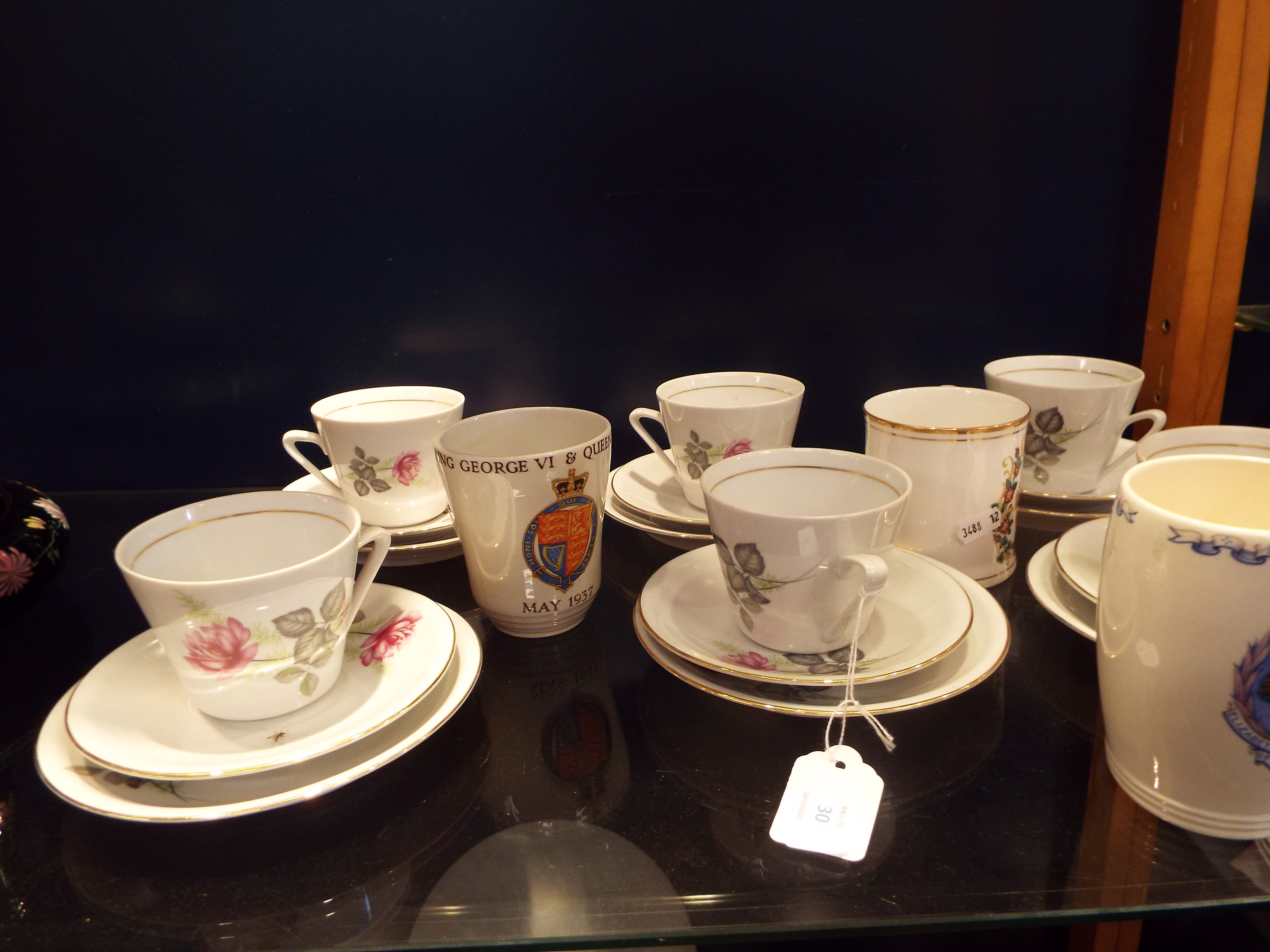 An Hungarian part tea-set with gilt banding and floral decoration and three commemorative mugs