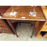 An early 20thC square oak side table with arched aprons raised on tapering ring turned supports