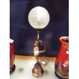 An Art Deco style bronzed table lamp in the form of a female dancer with frosted glass shade