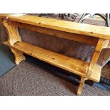 A pair of stained pine trestle end benches