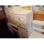 A cream and gilt bedroom suite comprising of dressing table and stool,