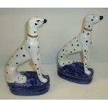 Pair of Staffordshire style seated dalmations on oval blue glazed bases with gilt finishing (one