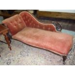 Victorian mahogany framed chaise lounge with elaborate carved wood frame and upholstered seat,