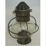 Ships paraffin lantern with glass globe within a wire cage