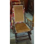 Victorian American style rocking chair on turned supports with upholstered seat back and arms