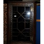 Carved oak corner cupboard with single glazed cupboard door