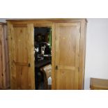 Modern light oak triple wardrobe with central bevelled edged mirrored panel with two drawers to