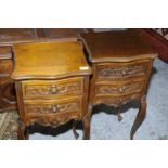 Pair of carved French style oak two drawer bedside cabinets on raised supports