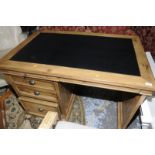 Modern light wood single pedestal desk with inset leather top, slide out tray and multiple drawers,