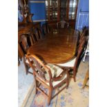 Regency style mahogany twin pedestal dining table with additional leaf and set of (6 + 2) wheat