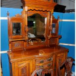 Late Victorian light wood dresser with raised mirrored back and carved detail above bow front,