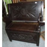 Carved oak monks bench with swivel top and lift up seat