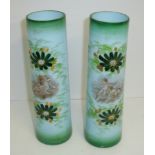 Pair of opaque glass vases with hand painted floral decoration and painted panels depicting cherubs