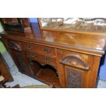 Early 20th C mahogany sideboard with two central drawers above open centre flanked by two carved