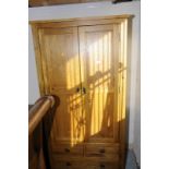 Modern light oak double door wardrobe with two short drawers above single long drawer