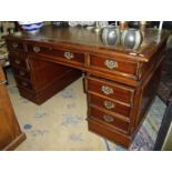 Modern mahogany twin pedestal desk with green tooled leather inset top with panelled detail to the