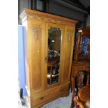 Early 20th C oak wardrobe with carved detail and central mirrored door above single drawer