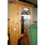 Pine corner cupboard with upper glazed cupboard door above open centre and single cupboard door