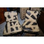 Pair of modern Stone International easy chairs with ebonized frames and leather work swab cushions