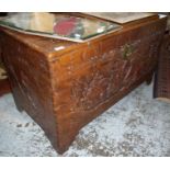 Heavily carved oriental camphor wood blanket box with hinged top and brass metal locking clasp