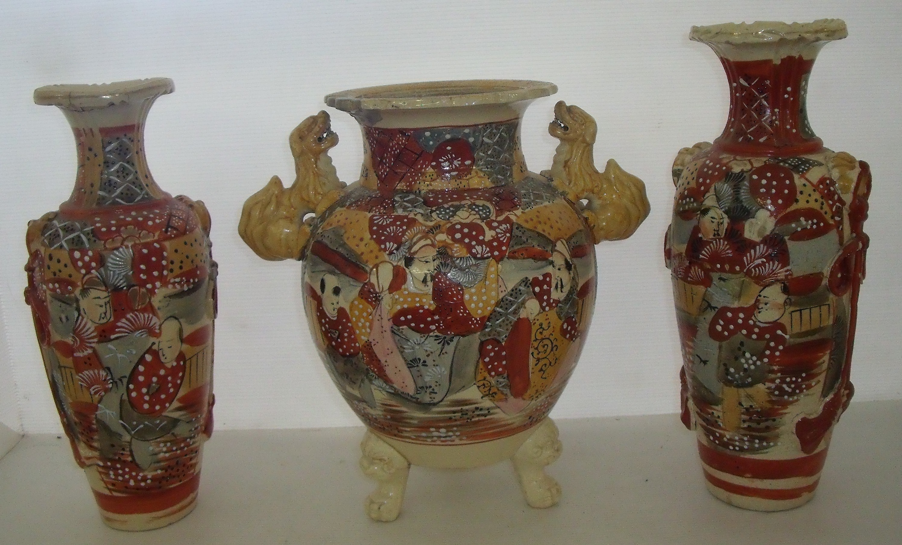 Large Japanese earthenware Satsuma ware vase on three raised dog of foe feet and pair of glazed