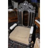 Baronial throne style chair with heavy carved detail,