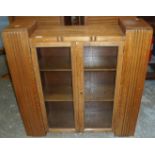 Art Deco light bookcase enclosed by two glazed doors with further open bookcases to the sides