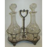 Victorian double decanter stand with silver plated rope twist frame and loop handle on scrolled