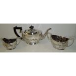 Three piece silver plated tea set with repousse floral pattern