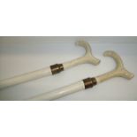 Pair of white painted walking sticks with ceramic thumb stick style handles