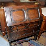 Oak bureau with panelled fall front above two drawers on barley twist supports