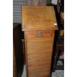 Early 20th C oak office style cabinet with roller shutter tambour door revealing slide out trays