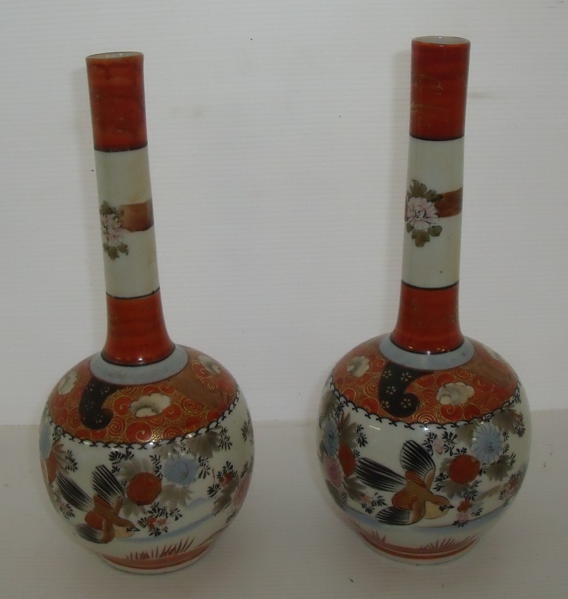 Pair of 19th C Chinese Kutani vases of globe and shaft form with stylized flowers and birds on a