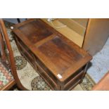 Mid-late 20th C oak panelled and carved blanket box (width 95cm)