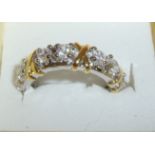 Silver and cz decorative band ring with yellow metal criss cross and interspersed with cz stones