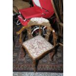 Late Victorian beech framed corner chair with carved detail and upholstered seat and back