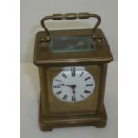 French brass cased carriage clock with white enamel dial bevelled edged glass panels