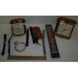 Two cased travelling clocks and a selection of various watch straps and clasps including Bulova