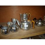 Four piece Picquotware tea set and a three piece stainless steel tea set