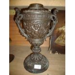 Cast twin handled urn with angels at play with elaborate handles (missing lid)